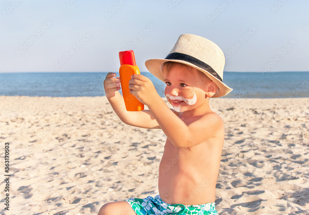The mustache drawing sunscreen on baby (boy) face. The mustache drawing sunscreen on baby (boy) face.
