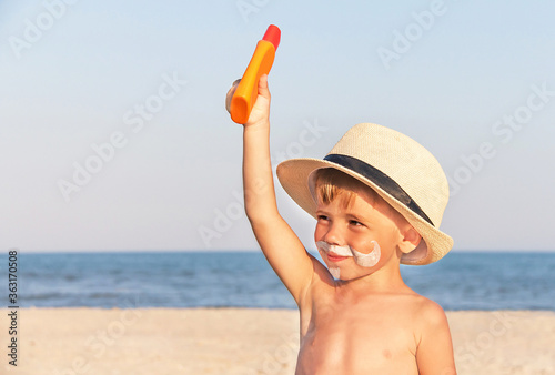 The mustache drawing sunscreen on baby (boy) face.