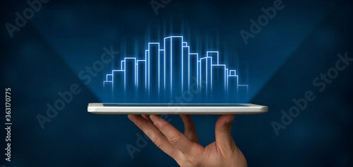 Hand Holding Tablet With Holographic Highrise Buildings, Blue Background, Collage