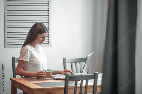 Girl working on computer laptop in light room © VERSUSstudio