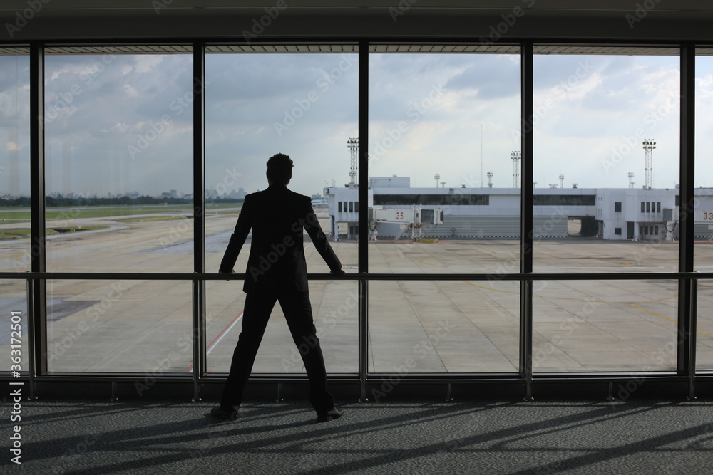Businessman waiting for his flight in airport lounge Businessman waiting for his flight in airport lounge