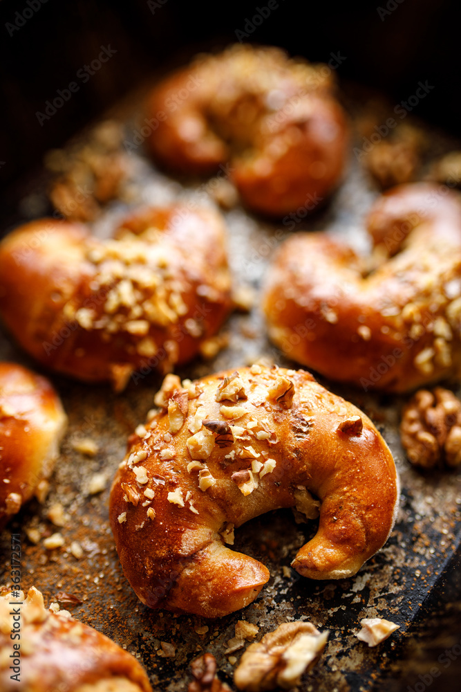 Yeast croissants with cinnamon and walnuts close up view
