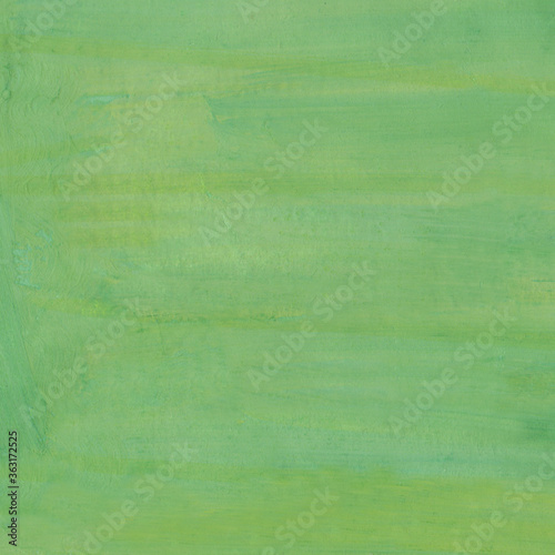 Strokes of tints of green gouache are on a paper. Texture