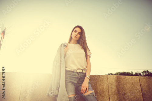 Summer sunny lifestyle fashion portrait. Young stylish hipster woman