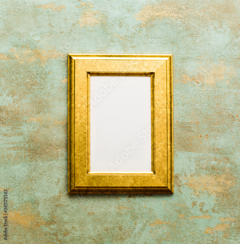 Golden wooden frame isolated on oxidized background.