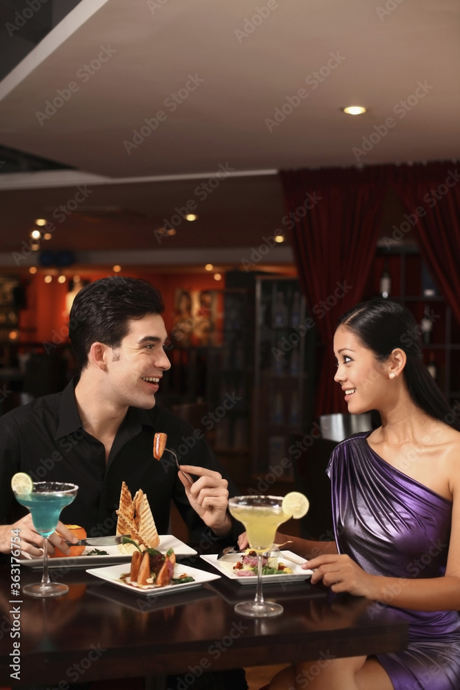 Man and woman chatting while having dinner together Man and woman chatting while having dinner together