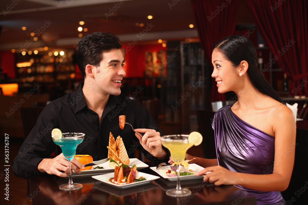 Man and woman chatting while having dinner together