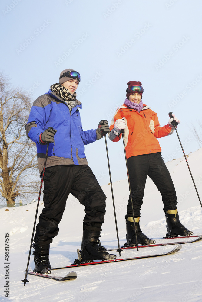 Man and woman skiing