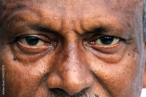 Obraz na plátně Senior Indian man's eyes and wrinkles on skin close view.