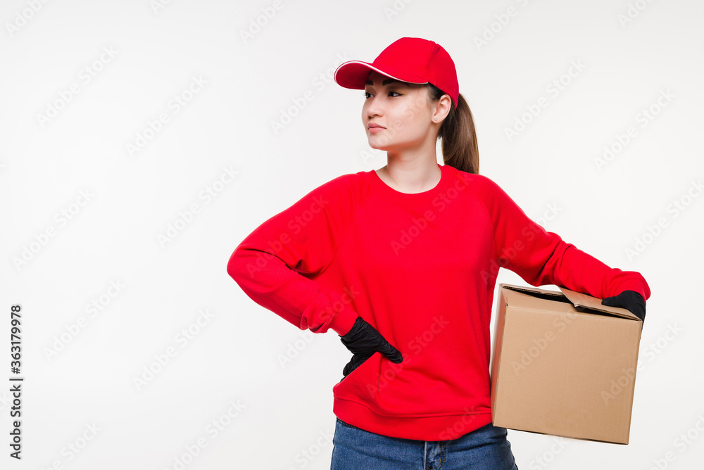 Delivery postal service asian woman holding and delivering package wearing red cap. Courier smiling happy isolated on white background. Delivery postal service asian woman holding and delivering package wearing red cap. Courier smiling happy isolated on white background.
