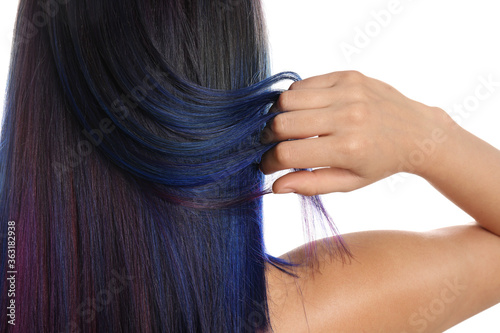 Young woman with bright dyed hair on white background, back view. Closeup