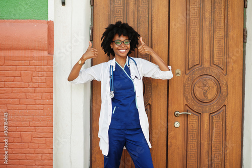 Portrait of African American female doctor with stethoscope wearing lab coat.