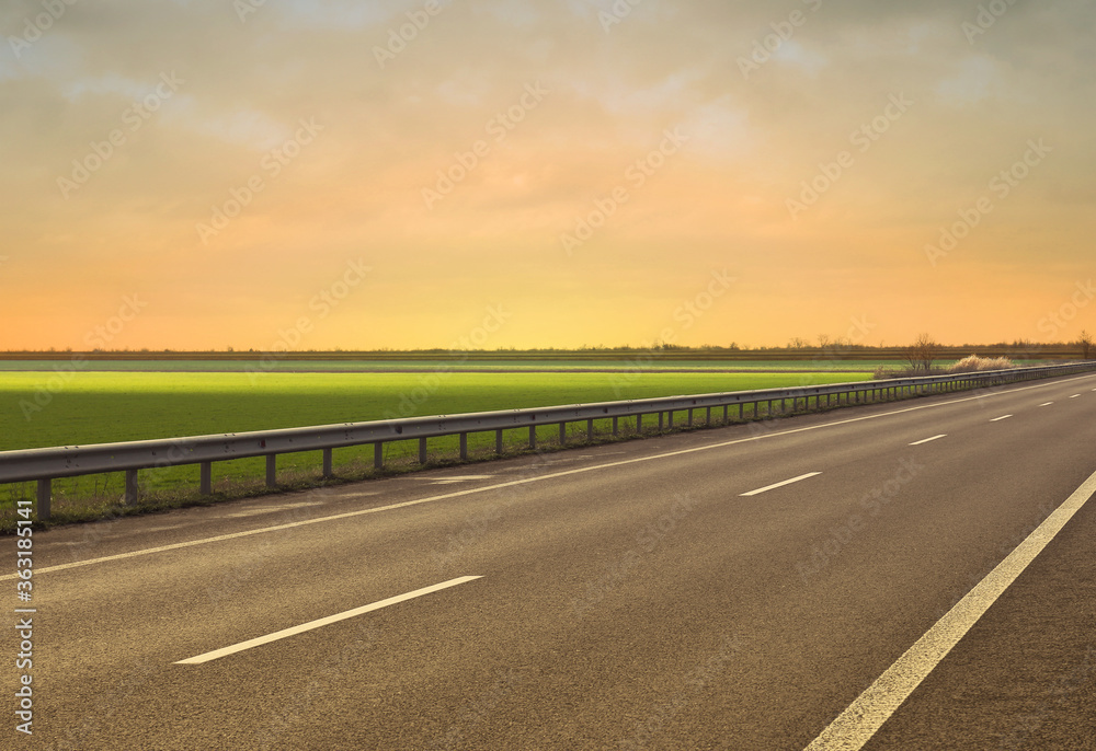 Road trip. Beautiful view of asphalt highway at sunset Road trip. Beautiful view of asphalt highway at sunset