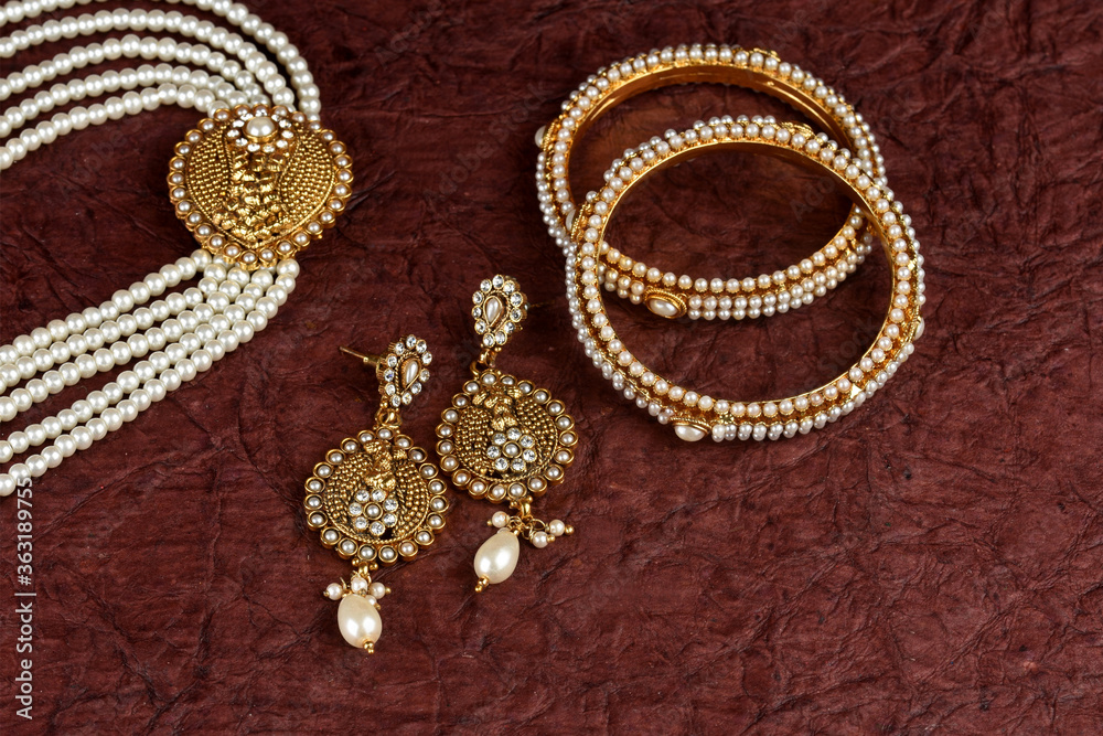 Pearl Jewelry on a textured background, Pearl bracelet, pearl necklace, pearl earrings, Style, fashion and design of jewelry. indian traditional jewellery,jewelry background Pearl Jewelry on a textured background, Pearl bracelet, pearl necklace, pearl earrings, Style, fashion and design of jewelry. indian traditional jewellery,jewelry background