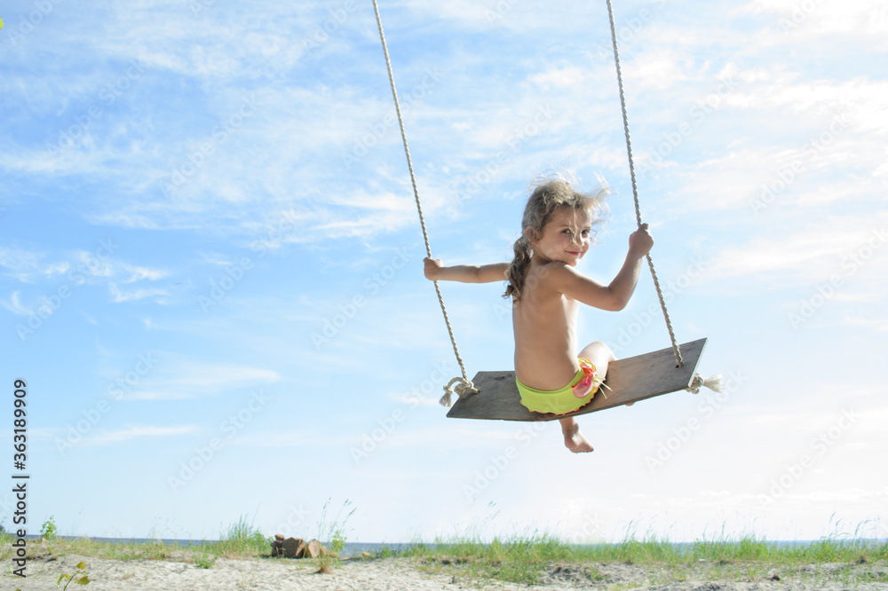 girl riding on a swing girl riding on a swing