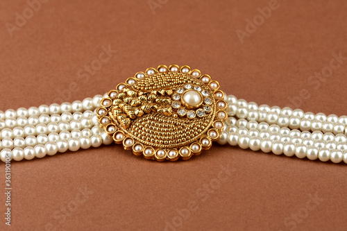 Pearl Jewelry on a brown background, Pearl bracelet, pearl necklace, pearl earrings.Style, fashion and design of jewelry. indian traditional jewellery