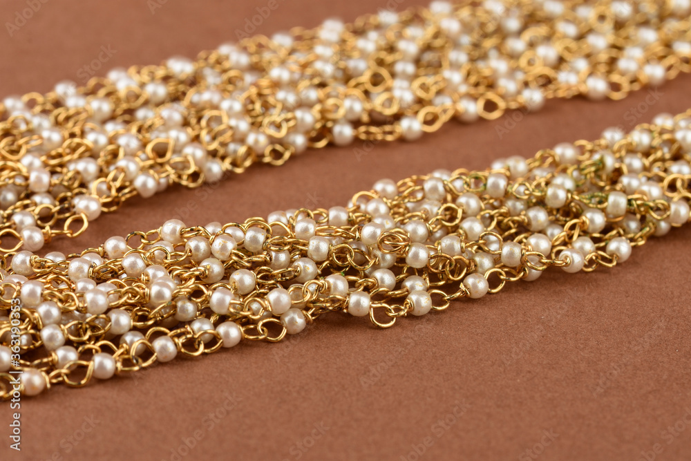 Pearl Jewelry on a brown background, Pearl bracelet, pearl necklace, pearl earrings.Style, fashion and design of jewelry. indian traditional jewellery Pearl Jewelry on a brown background, Pearl bracelet, pearl necklace, pearl earrings.Style, fashion and design of jewelry. indian traditional jewellery