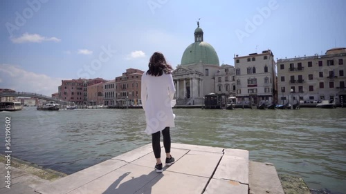Wallpaper Mural Young attractive woman walking and looking around near the grand canal in Venice Italy Torontodigital.ca