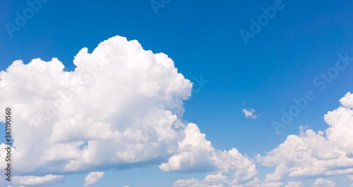 White clouds on blue sky background.