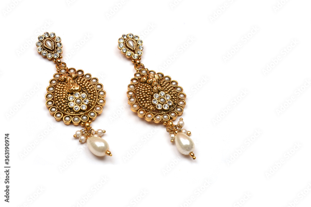 Beautiful Golden pair of earrings,pearls earrings on white background. Luxury female jewelry, Indian traditional jewellery, kundan earring,Bridal Gold earrings wedding jewellery Beautiful Golden pair of earrings,pearls earrings on white background. Luxury female jewelry, Indian traditional jewellery, kundan earring,Bridal Gold earrings wedding jewellery