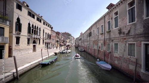 Wallpaper Mural Two men in a boat sail in canal. Venice Italy Torontodigital.ca
