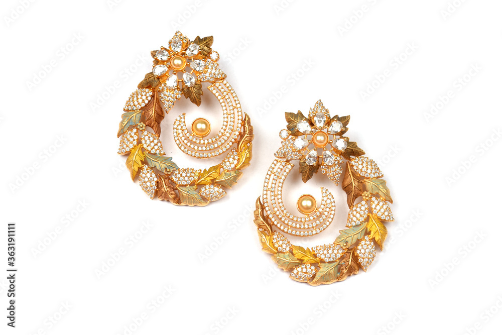 Fototapeta premium Glamorous antique Golden pair of earrings on white background. Luxury female jewelry, Indian traditional jewellery, kundan earring,Bridal Gold earrings wedding jewellery,Vintage earrings