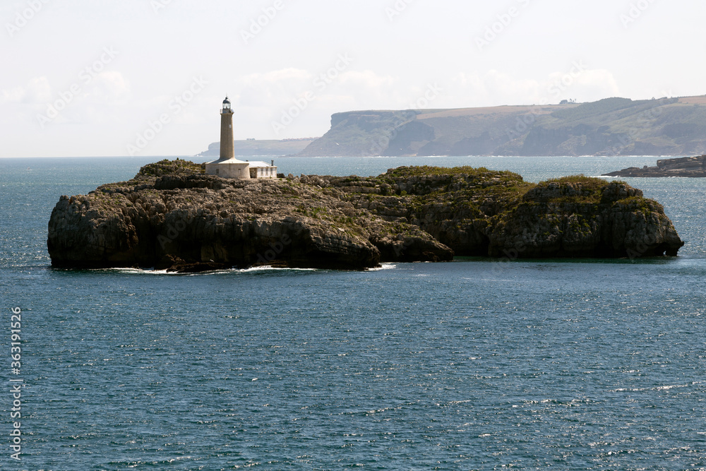 Beautiful lighthouse on an islet in the middle of the sea
