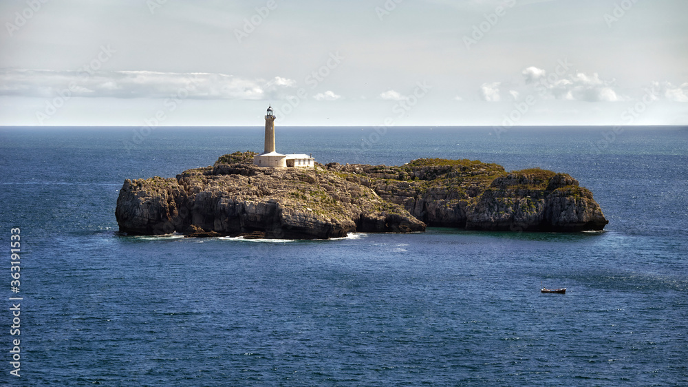 Beautiful lighthouse on an islet in the middle of the sea