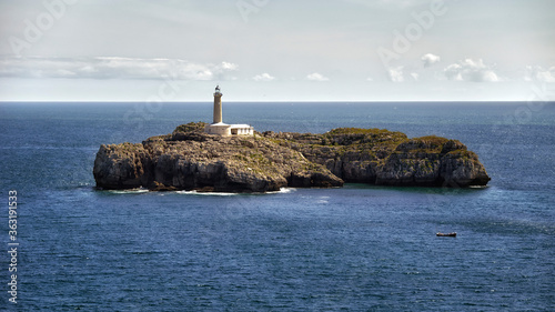 Beautiful lighthouse on an islet in the middle of the sea