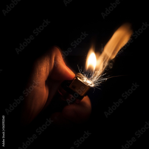 Flame and sparks from a lighter being lit.