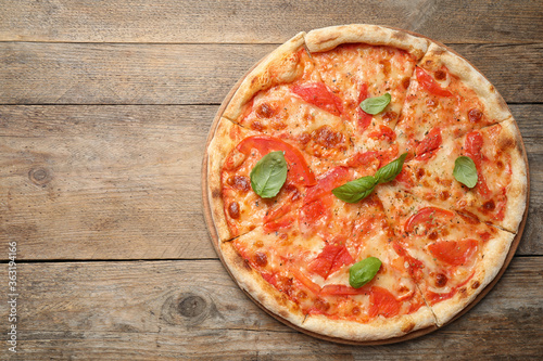 Delicious pizza Margherita on wooden table, top view. Space for text