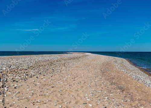 traditional summer landscape with sandy and pebbly promontory  blue sea and sky  Harilaid Nature Reserve  Estonia  Baltic Sea