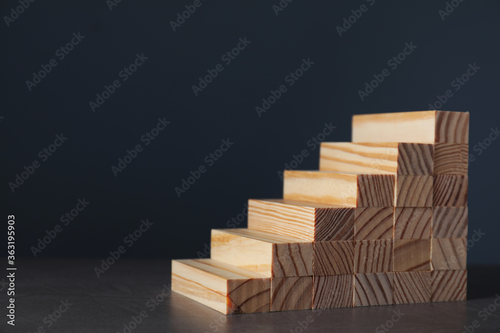 Steps made with wooden blocks on dark background, space for text. Career ladder Steps made with wooden blocks on dark background, space for text. Career ladder