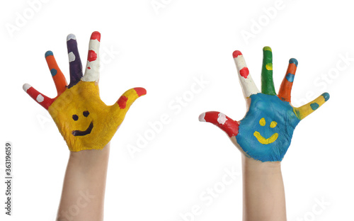 Kid with smiling faces drawn on palms against white background, closeup