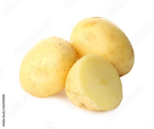 Whole and cut fresh raw organic potatoes on white background