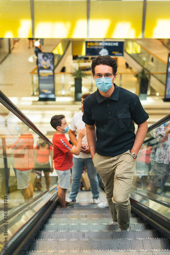 millennial group of boys visiting mall with face masks 