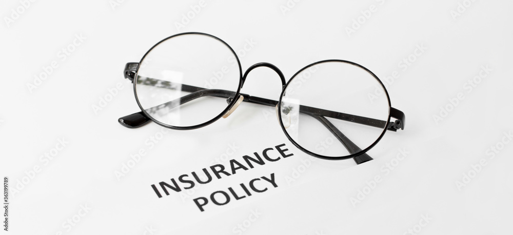 insurance policy form on desk in office showing risk concept insurance policy form on desk in office showing risk concept