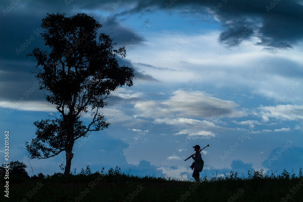 silhouette of a man walking on a hill silhouette of a man walking on a hill