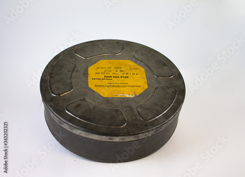An original old film can with an orange label. For 16 mm film rolls.