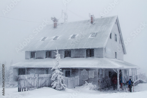 Fototapeta Naklejka Na Ścianę i Meble -  Hut covered with frost, standing on top of a mountain. Skrzyczne, Beskidy Slaski, Poland