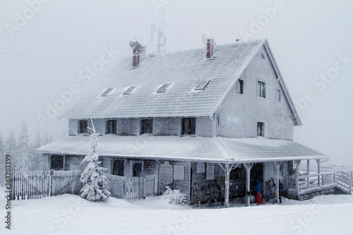 Hut covered with frost, standing on top of a mountain. Skrzyczne, Beskidy Slaski, Poland photo