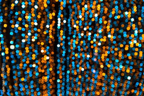 A lot of bokeh from a small blue and gold light on a Christmas decoration photo