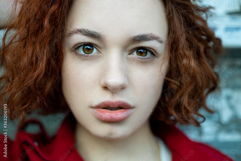 Fashion Portrait. Beautiful Woman in red coat. Curly Hair. soft focus Fashion Portrait. Beautiful Woman in red coat. Curly Hair. soft focus