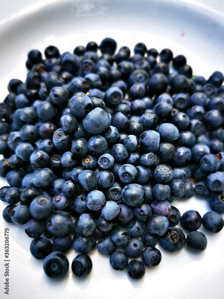 Blueberry (Vaccinium myrtillus). Blueberry fruit on a plate.
