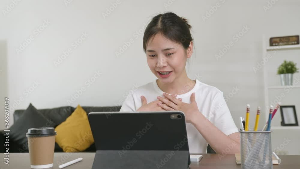 Young Asian woman using digital tablet and video call with learning online on internet. chatting with teacher. Young Asian woman using digital tablet and video call with learning online on internet. chatting with teacher.