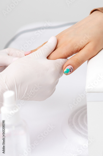 Female hand receiving hand massage by beautician hands in nail salon © okskukuruza