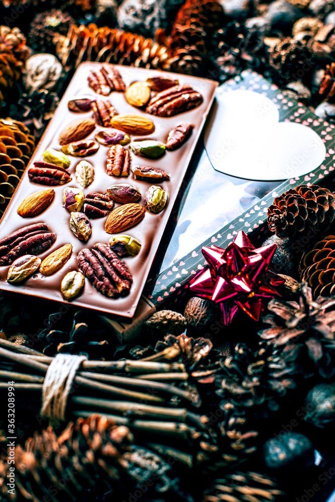 Composition of chocolate with nuts on cones background Composition of chocolate with nuts on cones background