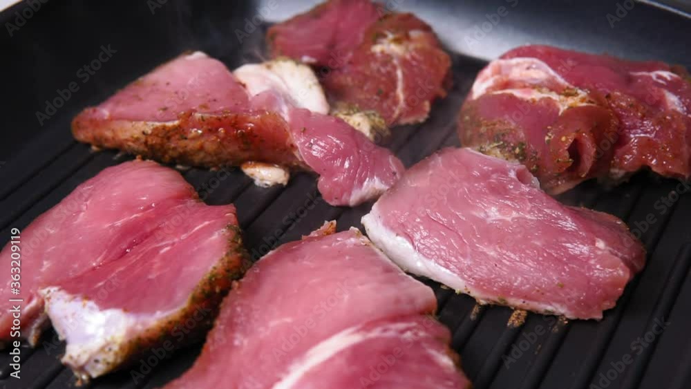 Piece of pork in a hot pan cooking hot meat, cooking delicious, close-up Piece of pork in a hot pan cooking hot meat, cooking delicious, close-up