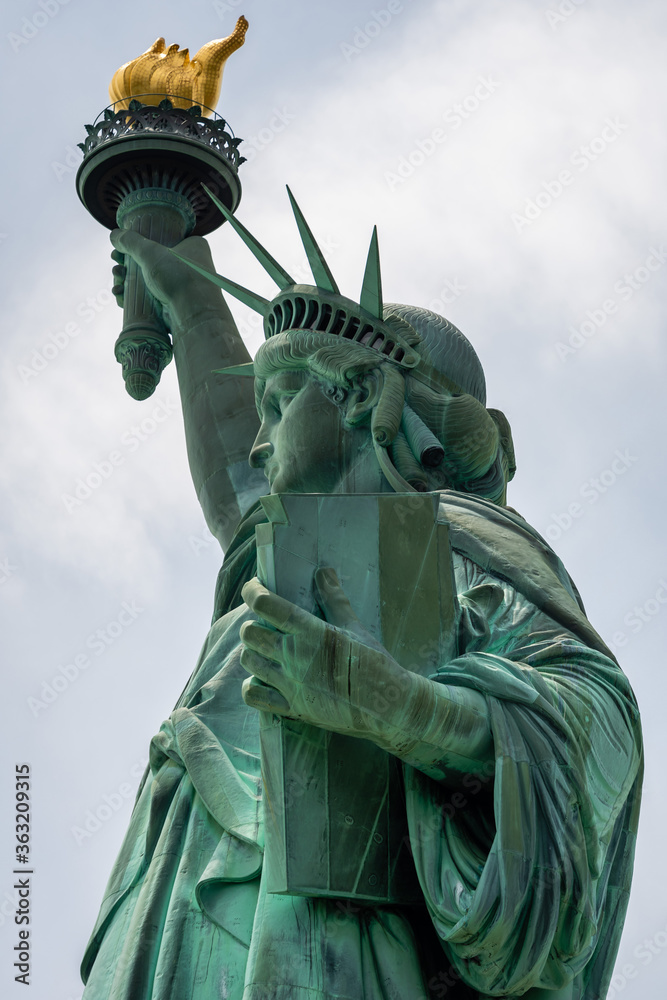 Fototapeta premium Statue of Liberty close up in a sunny day, blue sky in New York - Image