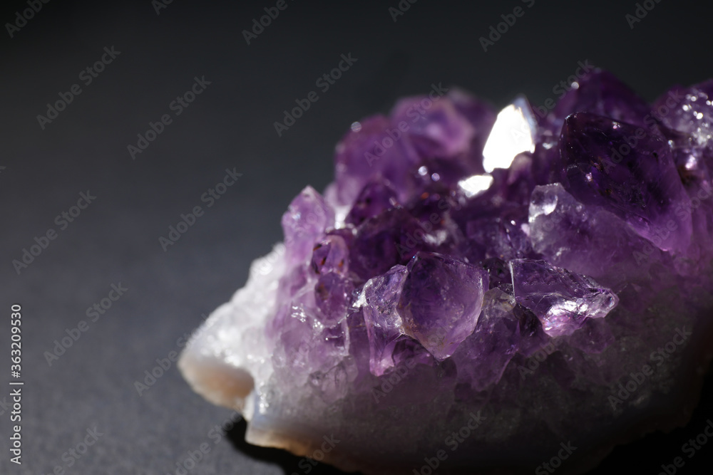 Beautiful amethyst on grey table, closeup. Healing crystal Beautiful amethyst on grey table, closeup. Healing crystal